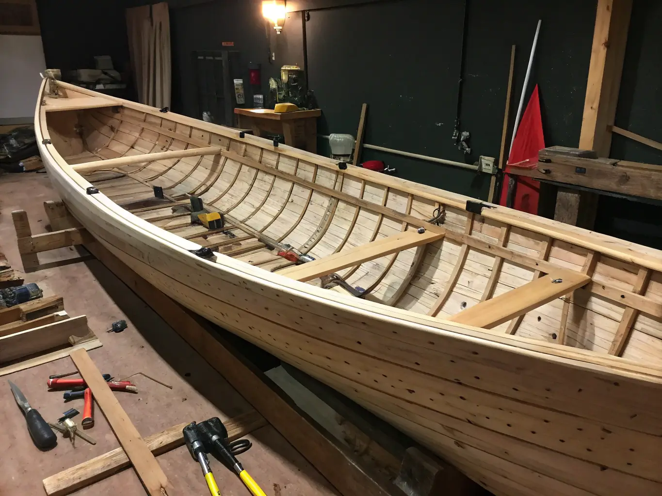 A photograph of volunteers restoring a traditional wooden boat, showcasing the craftsmanship and dedication involved in preserving maritime skills.